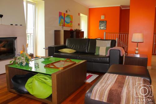a living room with a couch and a table at Solar do Carvalho in São Vicente