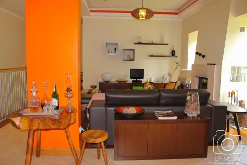 a living room with a couch and a table at Solar do Carvalho in São Vicente