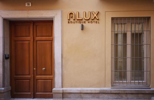 a building with two doors and a sign on it at Alux Boutique Hotel in Málaga