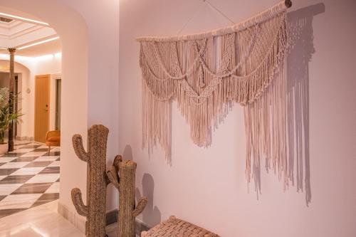 a room with a chandelier hanging from a wall at Alux Boutique Hotel in Málaga