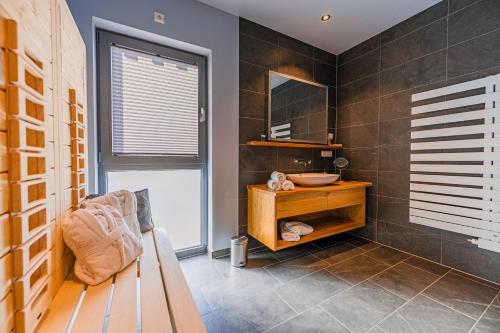 a bathroom with a bench and a sink in it at Glück Auf in Seiffen