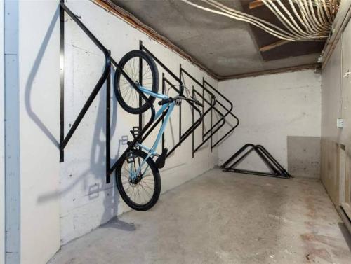 a bike hanging on a wall in a room at Casa Creekside - Walk to Gondola, Shops, lakes! in Whistler