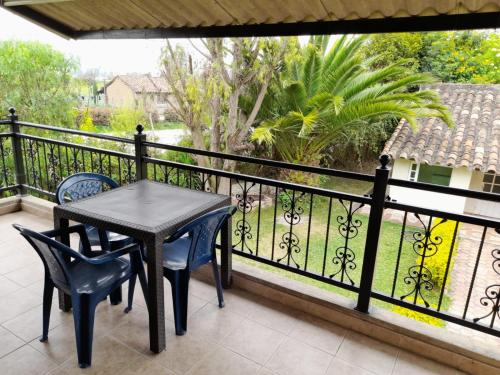 a table and chairs on a balcony with a view at Reserva de Santa Ines Valle de Tibasosa in Tibasosa