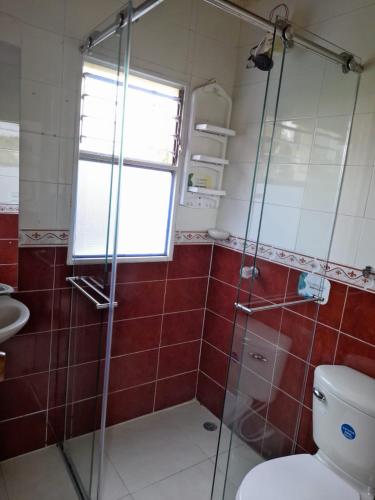 a bathroom with a shower and a toilet at Reserva de Santa Ines Valle de Tibasosa in Tibasosa