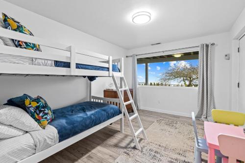 a bedroom with a bunk bed and a desk at Sunrise Paradise in Camano