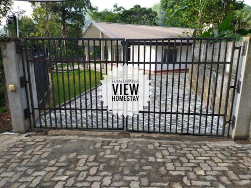 a black gate with a sign on it at Hanthana View Homestay in Kandy