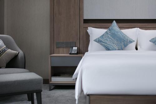 Cama ou camas em um quarto em NATIONAL SCENIC SPOT SUNSHINE RESORT HOTEL