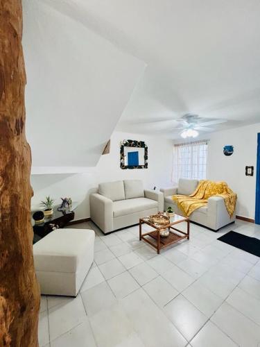 a living room with two couches and a table at La Casa del Capi in Cancún