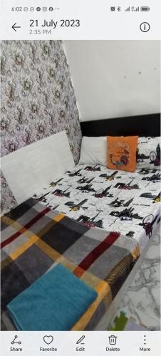 a picture of a bed with a quilt on it at Ultimate in Abu Dhabi