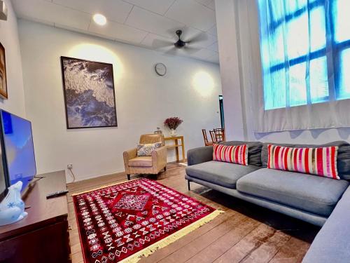 a living room with a couch and a rug at Pertak Malai @ Kuala Kubu Bharu in Kuala Kubu Baharu