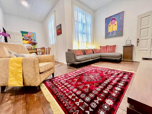 a living room with a couch and a red rug at Pertak Malai @ Kuala Kubu Bharu in Kuala Kubu Baharu