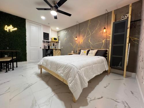 a bedroom with a bed with a marble wall at Busch Gardens Bliss Suite-2 in Tampa
