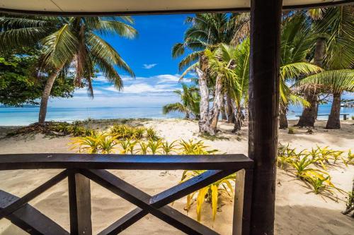a view of the beach from the porch of a resort at Mana Backpackers and Dive Resort in Mana Island