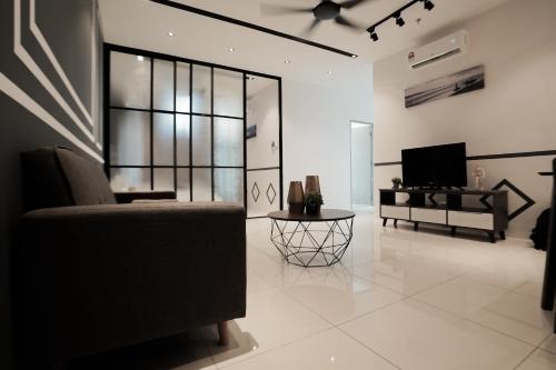 a living room with a couch and a tv at ITCC Manhattan Suites by Calvin in Donggongon