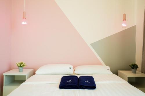 two blue pillows sitting on a bed in a room at ITCC Manhattan Suites by Calvin in Donggongon