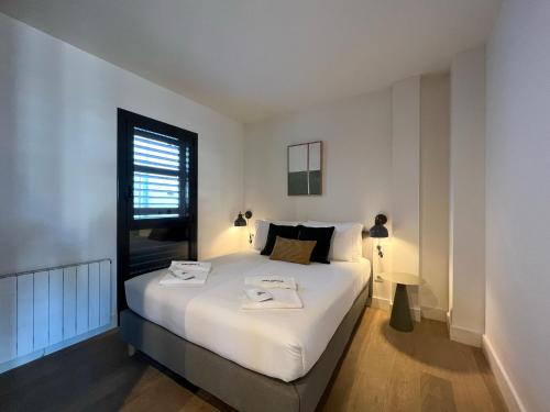 a bedroom with a bed with two towels on it at Stay U-nique Apartment Pau Claris in Barcelona