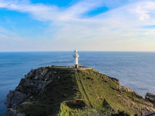 a lighthouse on top of a cliff in the ocean at Guest House Goto Times - Vacation STAY 59196v in Goto