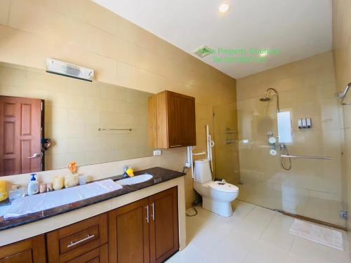 a bathroom with a sink and a toilet and a shower at orchid palm home 5 in Hua Hin