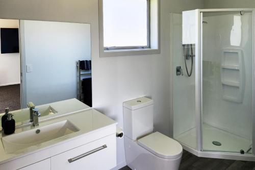 a bathroom with a shower and a toilet and a sink at Glen View Escape in Twizel