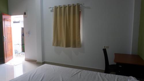 Un pat sau paturi într-o cameră la Maria Guesthouse