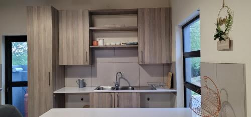 a kitchen with wooden cabinets and a sink at Jackal Creek Golf Estate in Roodepoort