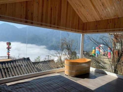 a room with a large window with a view of a mountain at Daisy Sapa - Homestay - Panorama in Lao Cai