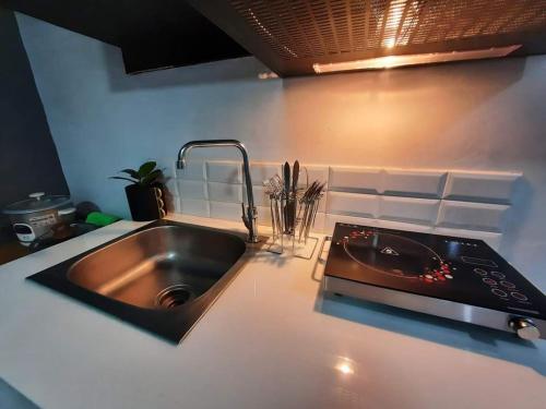 a kitchen with a sink and a stove at L1 Twin Bed Staycation in Bonifacio Global City 4 in Manila