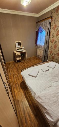 a bedroom with a bed and a desk with a laptop at RO METRO in Gyumri