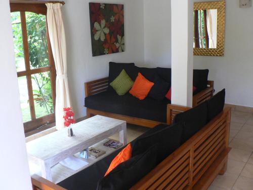 a living room with a couch and a table at Villa Tenganan, Candidasa, Bali in Candidasa