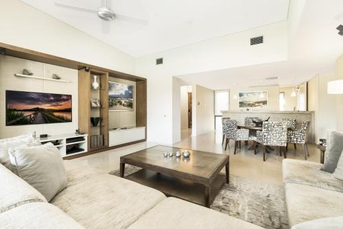 a living room with a couch and a table at Mindil Beach Casino Resort in Darwin