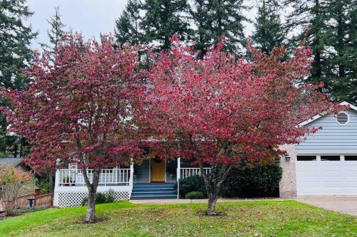 two trees with red leaves in front of a house at Sopra Bella- 4 bedroom home in Corvallis