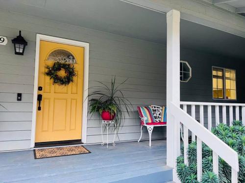 a front door of a house with a yellow door at Sopra Bella- 4 bedroom home in Corvallis