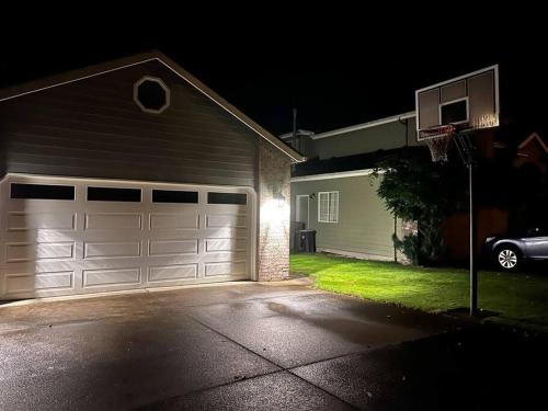 a house with a garage at night at Sopra Bella- 4 bedroom home in Corvallis