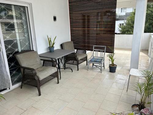 a patio with chairs and a table on a balcony at BLEU TROPICAL in Grand Baie