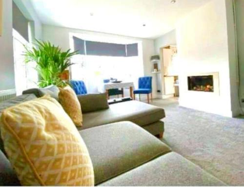 a living room with a couch and a fireplace at Greenfields Spa with private hottub New listing in Malvern Link