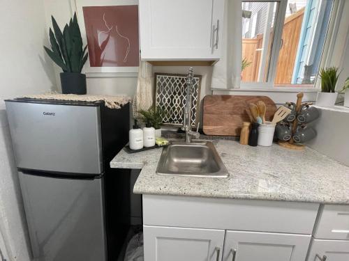 a kitchen with a white refrigerator and a sink at Private studio near Green Lake/Lightrail/I-5 in Seattle