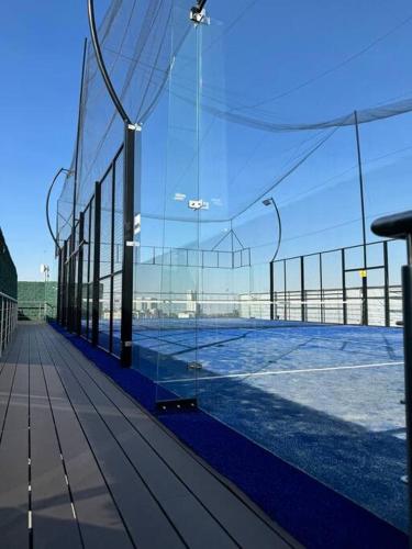 a view of a tennis court through a glass wall at The best place to live and work in Mexico City
