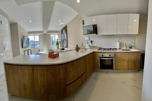 a kitchen with a large island in the middle at The best place to live and work in Mexico City