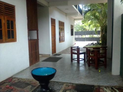 a room with a table and a blue stool at Black Panther Yala in Tissamaharama