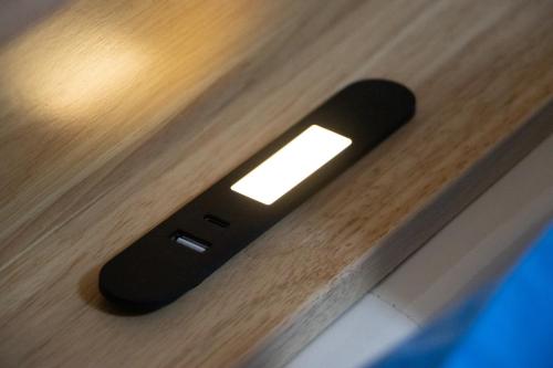 a remote control sitting on top of a wooden table at Thai Life Guesthouse Khaolak in Khao Lak