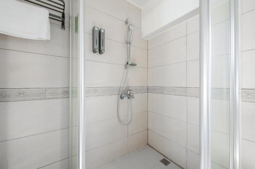 a bathroom with a shower with a glass door at White House in Xiaoliuqiu