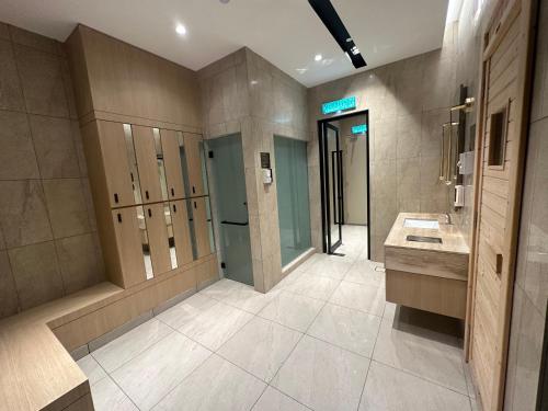 ein Bad mit 2 Waschbecken und einer ebenerdigen Dusche in der Unterkunft Axon Residence By Leo Suites in Kuala Lumpur