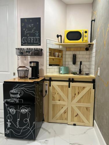a kitchen with a black refrigerator and a microwave at Busch Gardens Bliss Suite-2 in Tampa