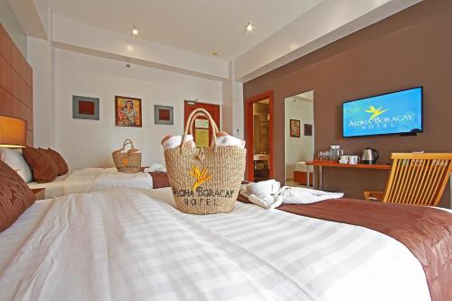 a bedroom with a bed with baskets on it at Aloha Boracay Hotel in Boracay