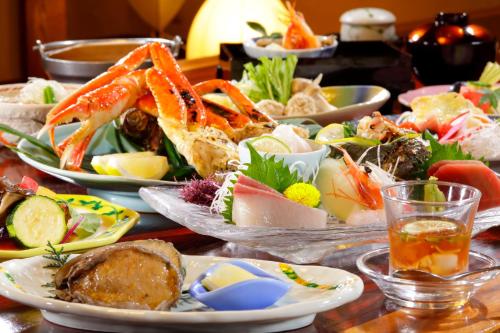 a table full of plates of food with seafood at 海のほてる　いさば in Numazu