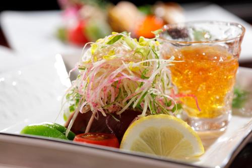 a plate of food with a salad and a drink at 海のほてる　いさば in Numazu