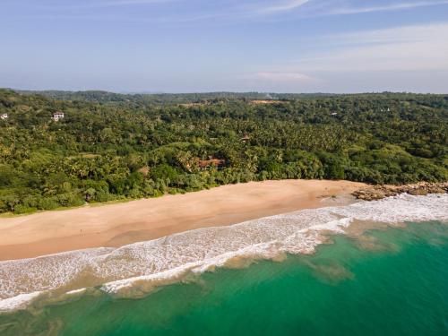 an aerial view of a beach and the ocean at The Last House in Tangalle