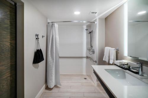 a bathroom with a shower and a sink at Crowne Plaza Atlanta SW - Peachtree City, an IHG Hotel in Peachtree City