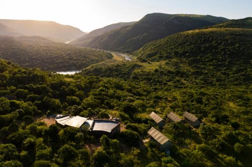 an aerial view of a house in a valley at Matatane Camp - Babanango Game Reserve in Nkwalini