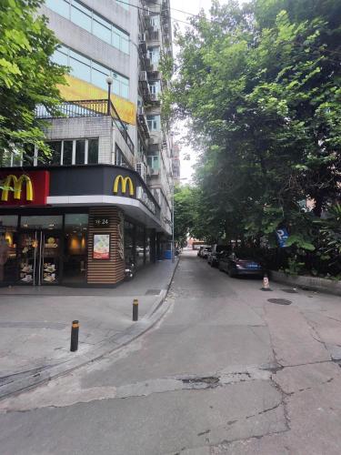 an empty street with a mcdonalds restaurant on a city street at Echarm PLUS International Hotel Zhujiang New Town Wuyangcun Metro Station Branch- Free Deliver Service to Canton Fair Complex During Canton Fair Period in Guangzhou